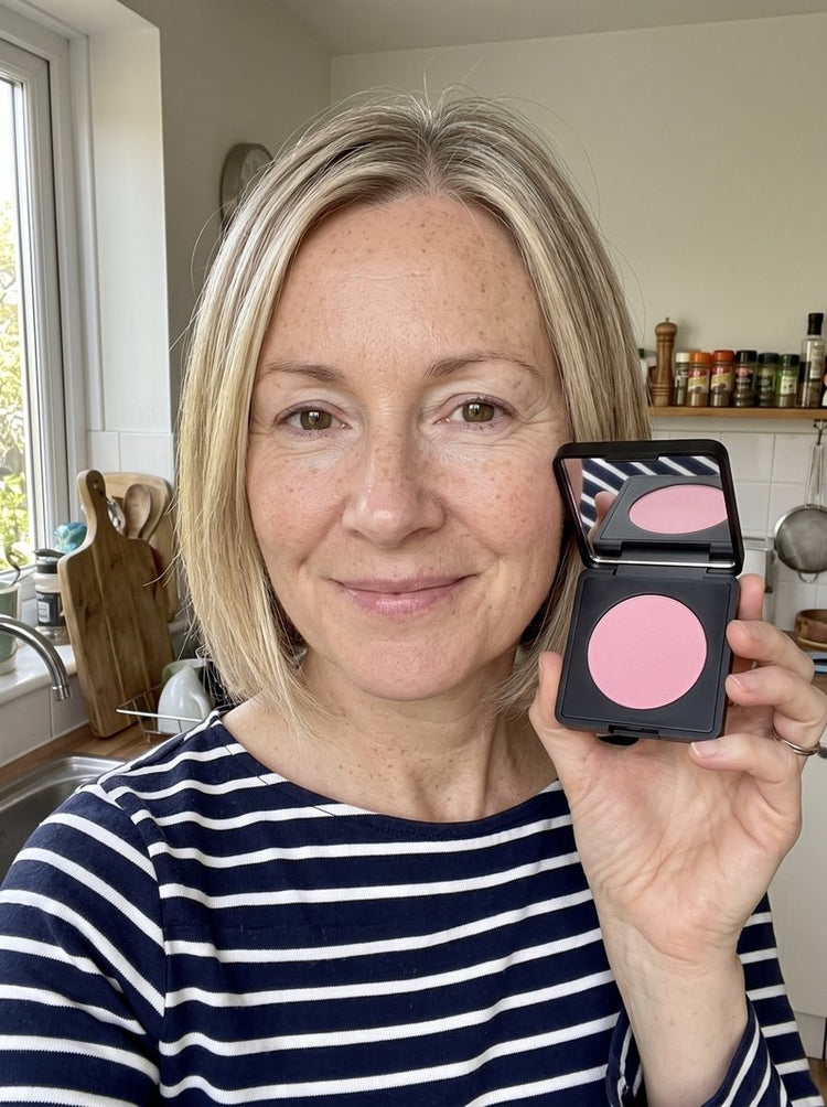Ashleigh B. at home with the brightener on, holding the compact